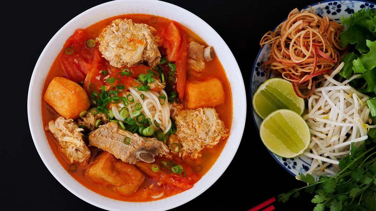 Bun rieu is a beloved Vietnamese noodle soup known for its distinctive orange-red broth made from freshwater crab and tomatoes